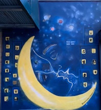 a mural of a moon and stars on a building